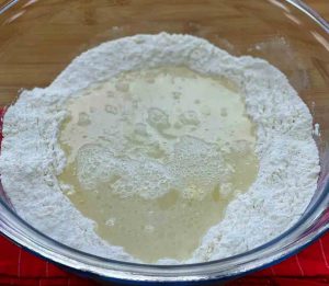 combine yeast with sugar and half a cup of lukewarm water
