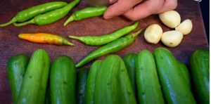 Put garlic, dill and tarragon on the cucumbers