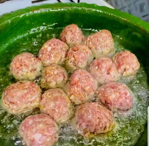 fry meatballs in pan with oil